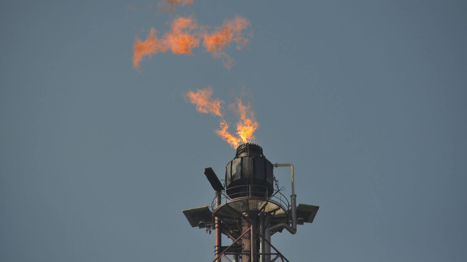 A flare stack burning off gas at an industrial plant.