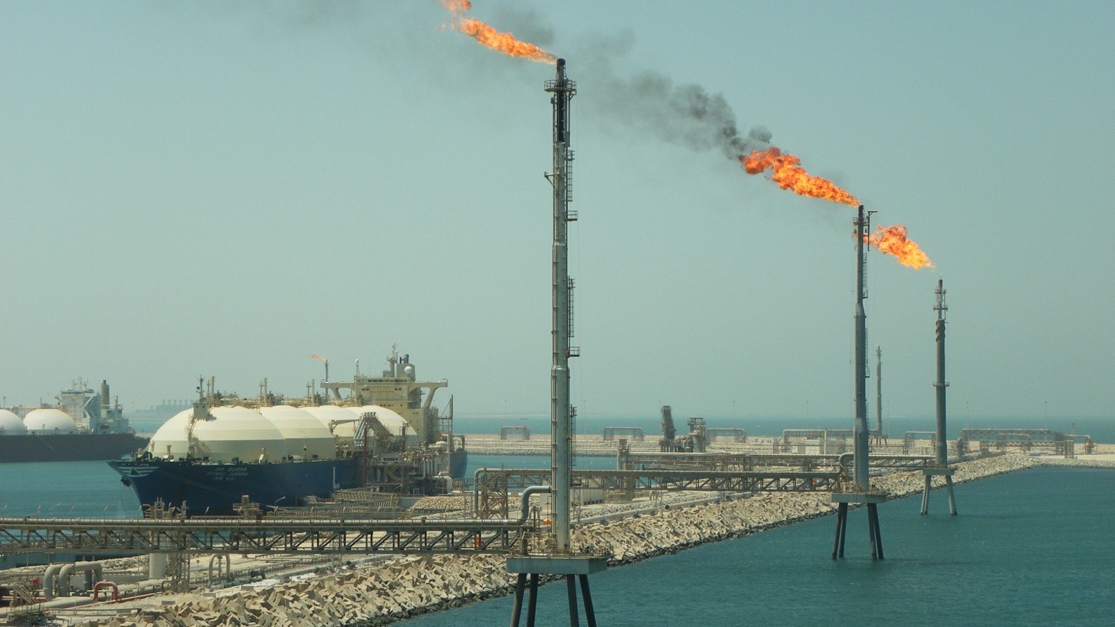 Pipe racks, flare stacks and an LNG carrier at a Gulf coast gas terminal